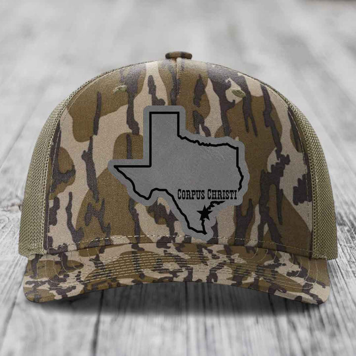 Blue and white trucker hat with gray Texas outline patch reading &
