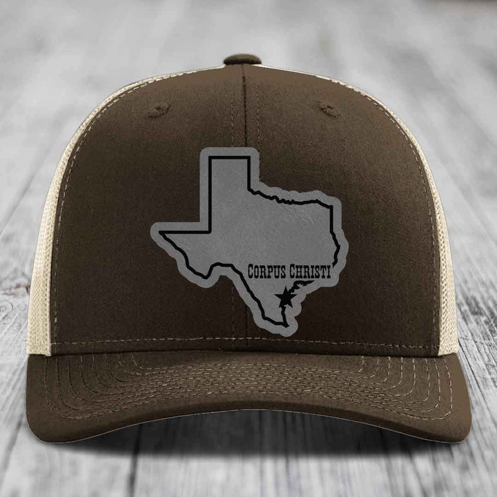 Green trucker hat with gray Texas outline patch, "Corpus Christi" text, and star marker.