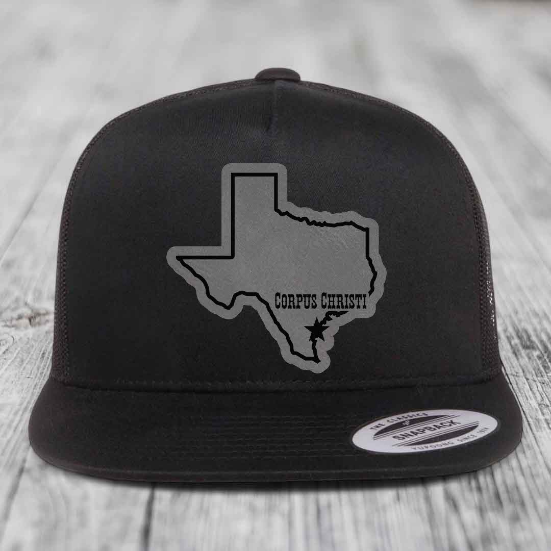Black and white trucker hat with grey Texas outline patch marked &