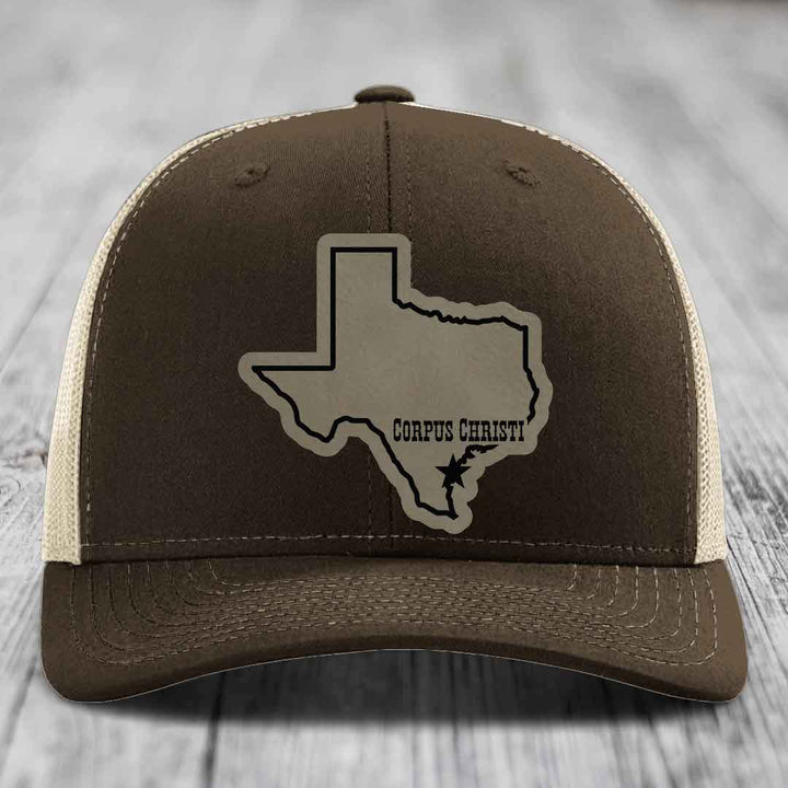 Green trucker hat with tan leather patch of Texas state outline and &