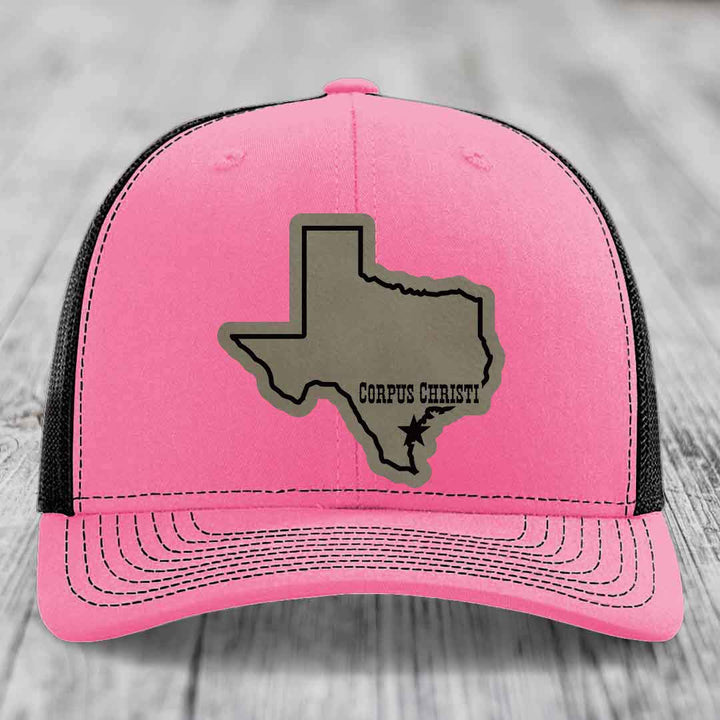 Green trucker hat with beige Texas outline patch, "Corpus Christi" text, and star marker.