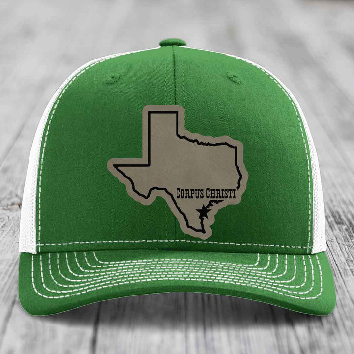 Beige trucker hat with black mesh back, featuring a Texas state outline patch with &
