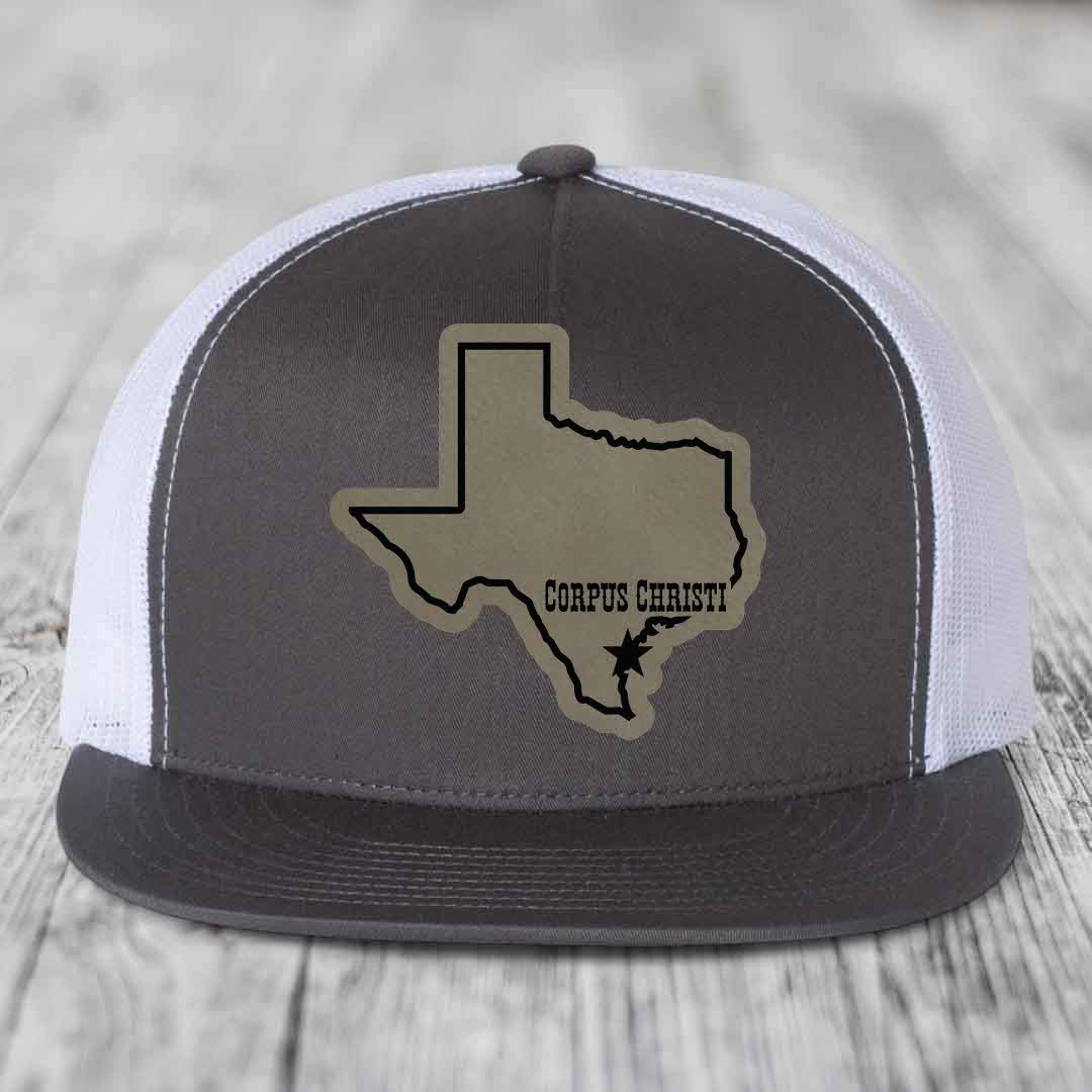 Black snapback hat with brown leather patch of Texas state outline and &