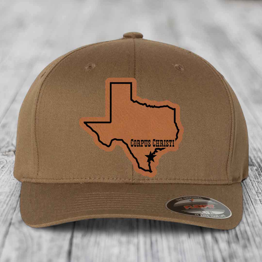 Tan baseball cap with brown leather patch of Texas state outline and &
