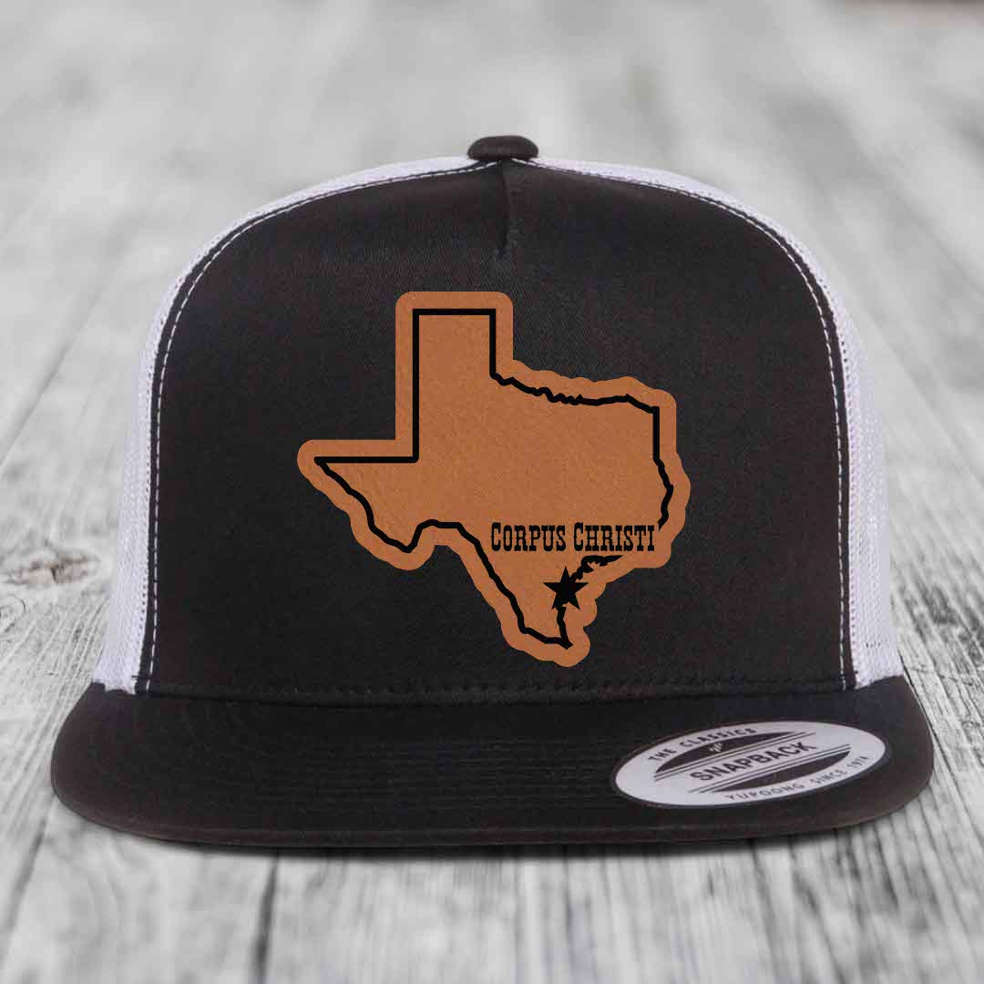Grey trucker hat with brown leather patch of Texas state outline and &