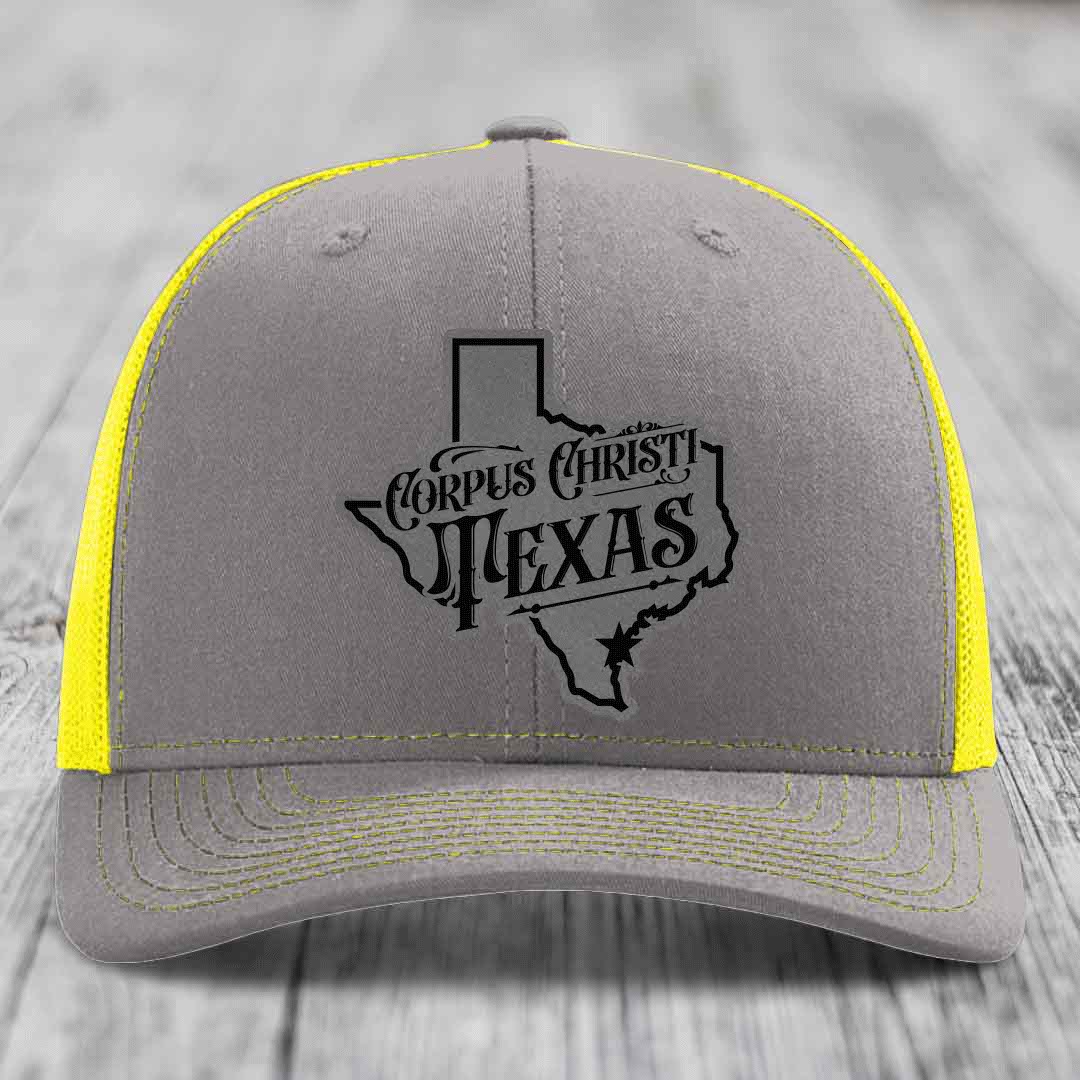 Brown trucker hat with gray Corpus Christi Texas patch on front, beige mesh back.
