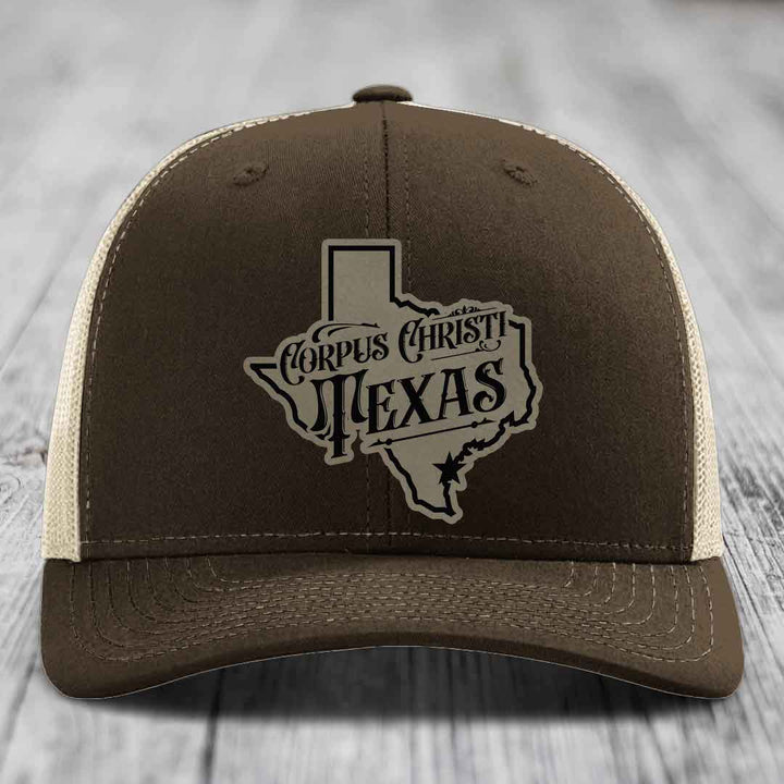 Green trucker hat with Corpus Christi Texas leather patch on front.