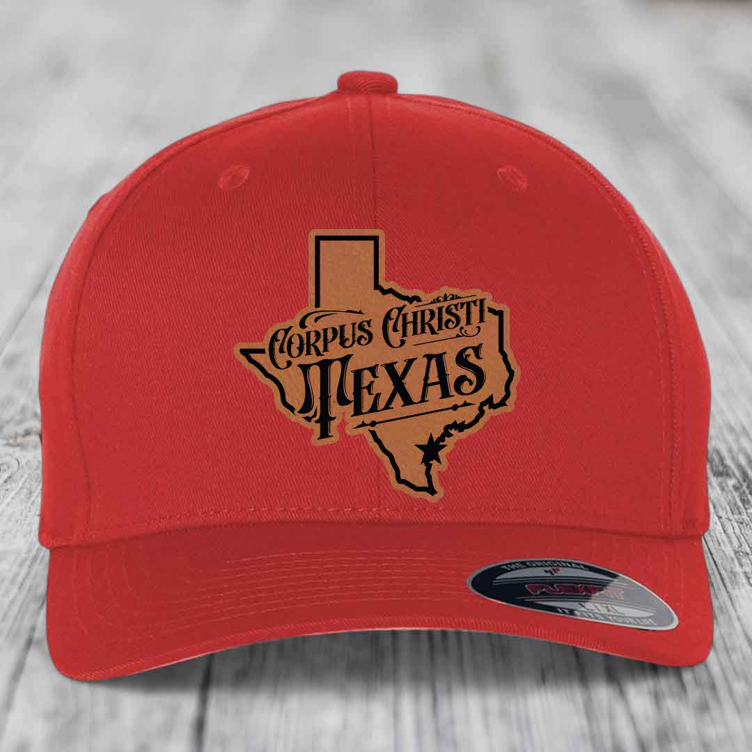 Red baseball cap with grey and black Corpus Christi, Texas patch on front.
