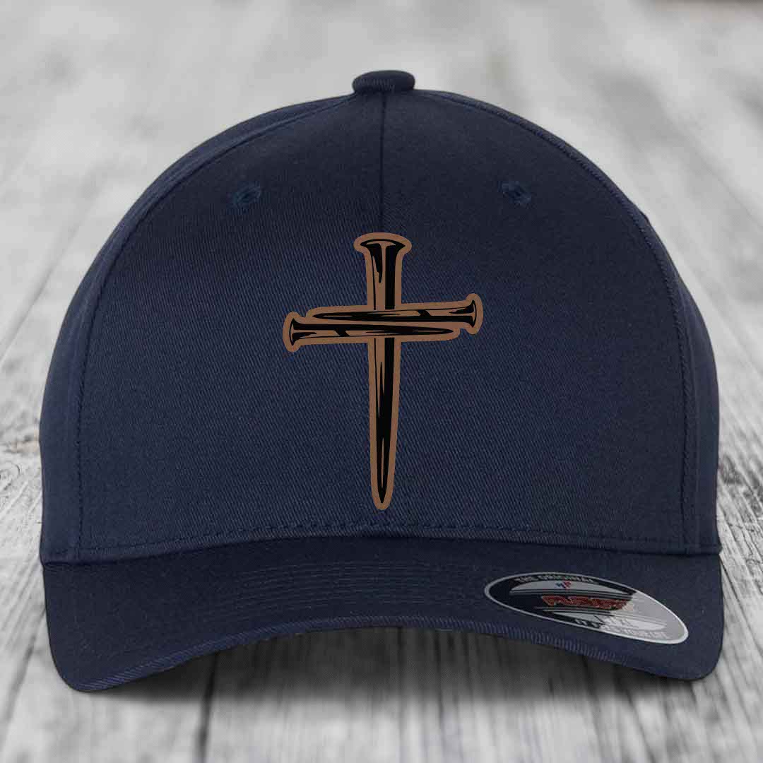 Dark blue baseball cap with a cross made of nails patch on front.