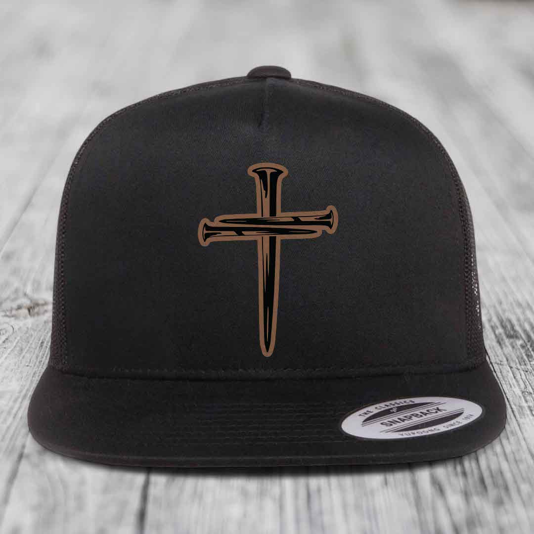 Black and white trucker hat with a cross made of nails patch on front.