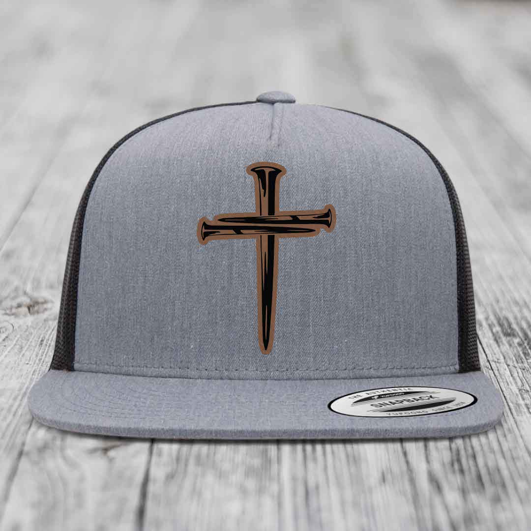Grey trucker hat with a cross made of nails patch on front.