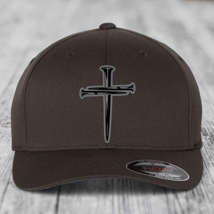 Dark brown Flexfit hat with a cross of nails patch on front.