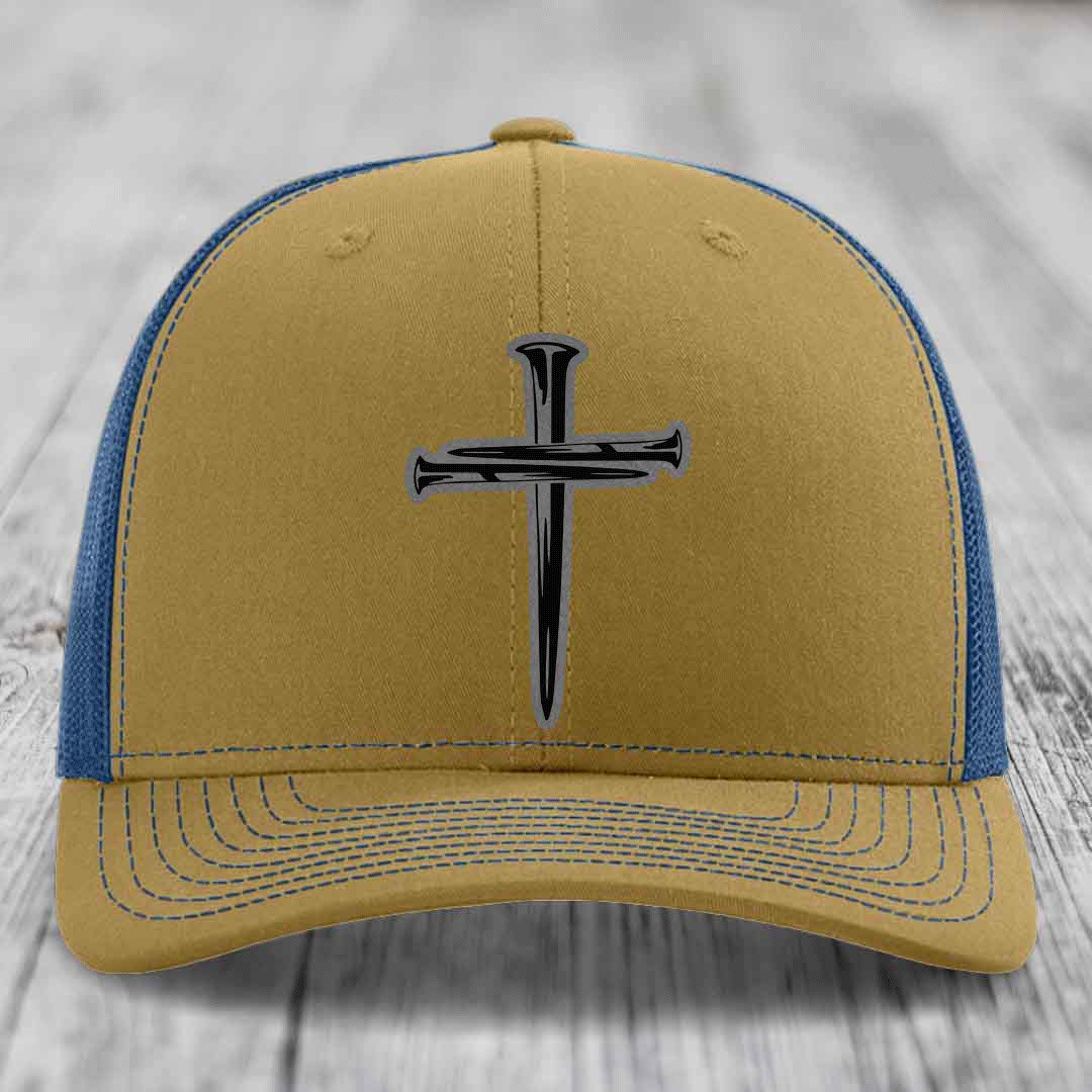 Black trucker hat with a silver cross made of nails embroidered on the front.
