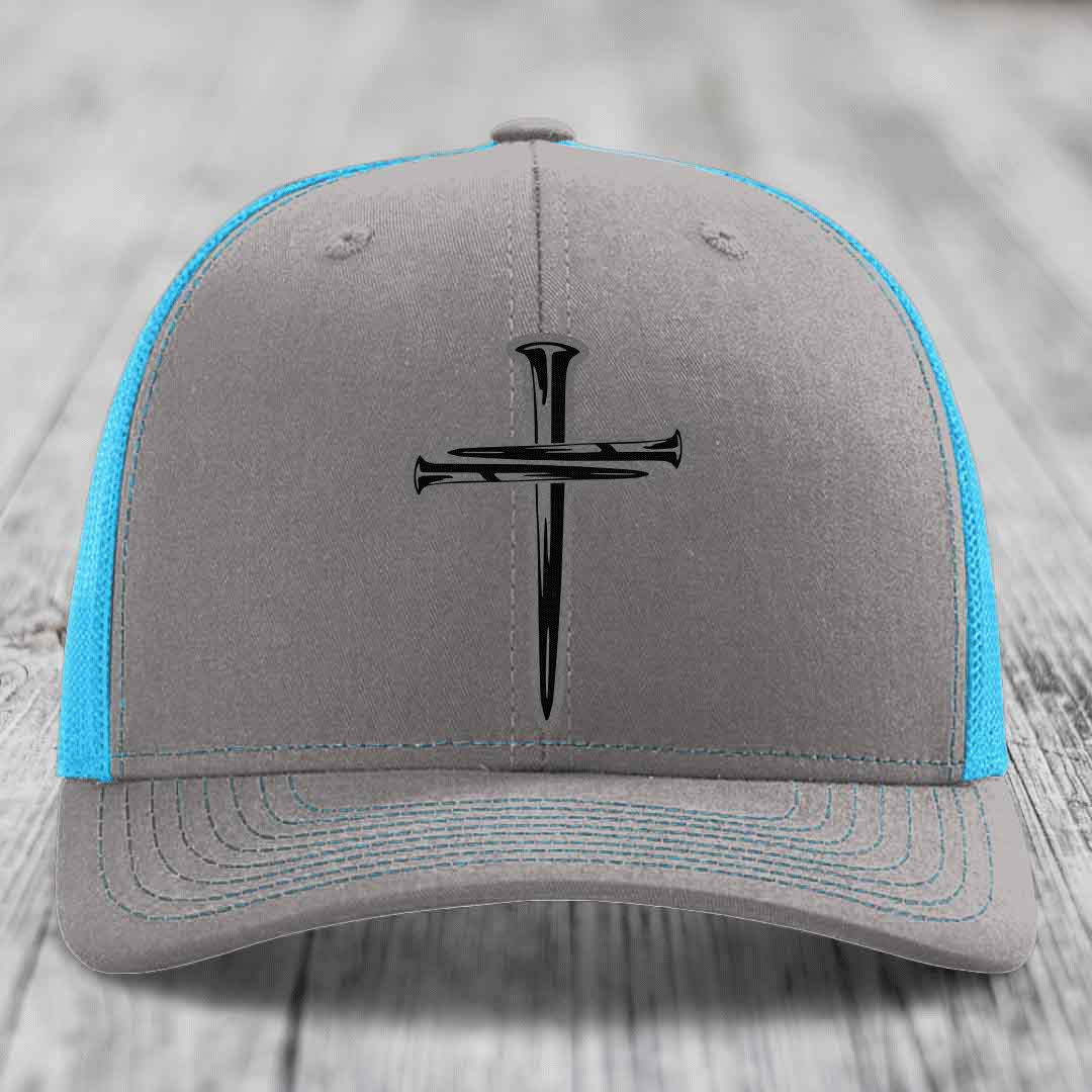 Grey trucker hat with black cross of nails patch and neon green mesh panels.
