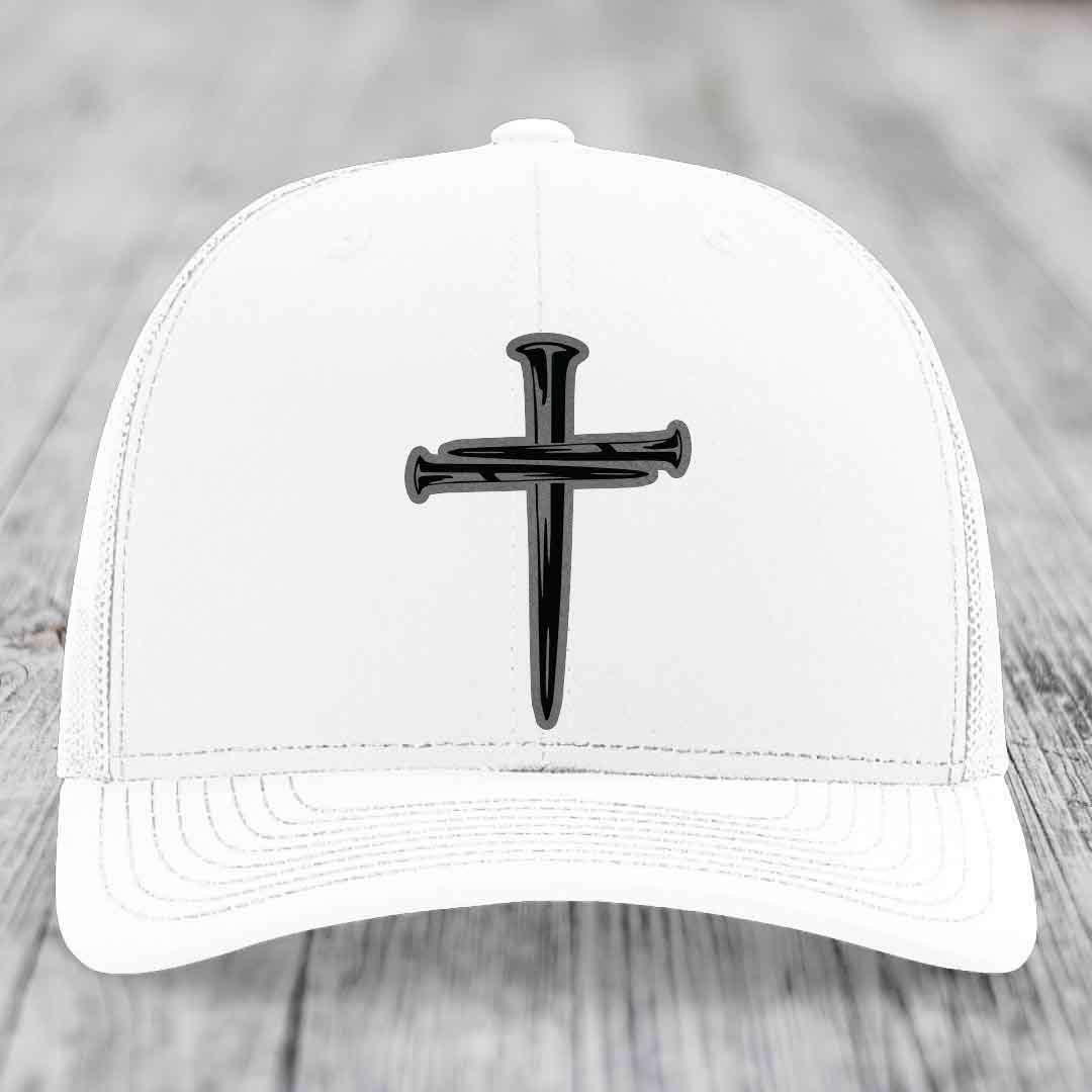 Black trucker hat with a cross made of nails patch on front.