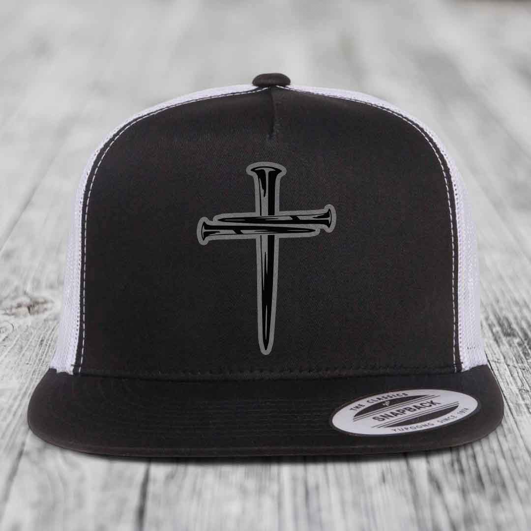 Grey trucker hat with black cross of nails patch on front.