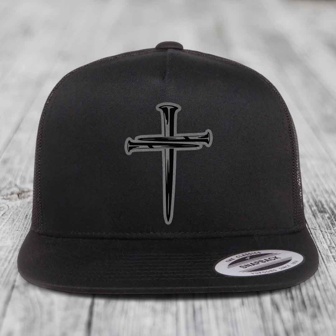 Black and white trucker hat with a cross made of nails patch on front.