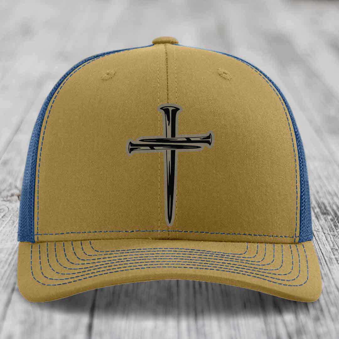 Black trucker hat with a cross made of nails patch on front.