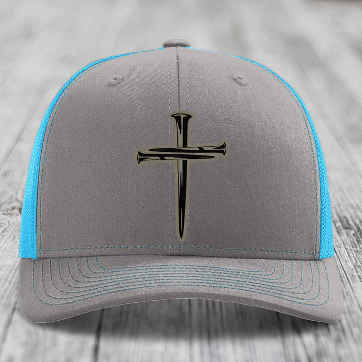 Grey trucker hat with neon green mesh and stitching, featuring a black cross of nails patch on front.