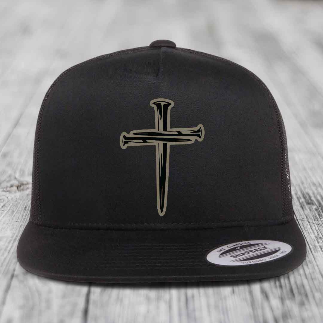 Black and white trucker hat with a cross made of nails patch on front.