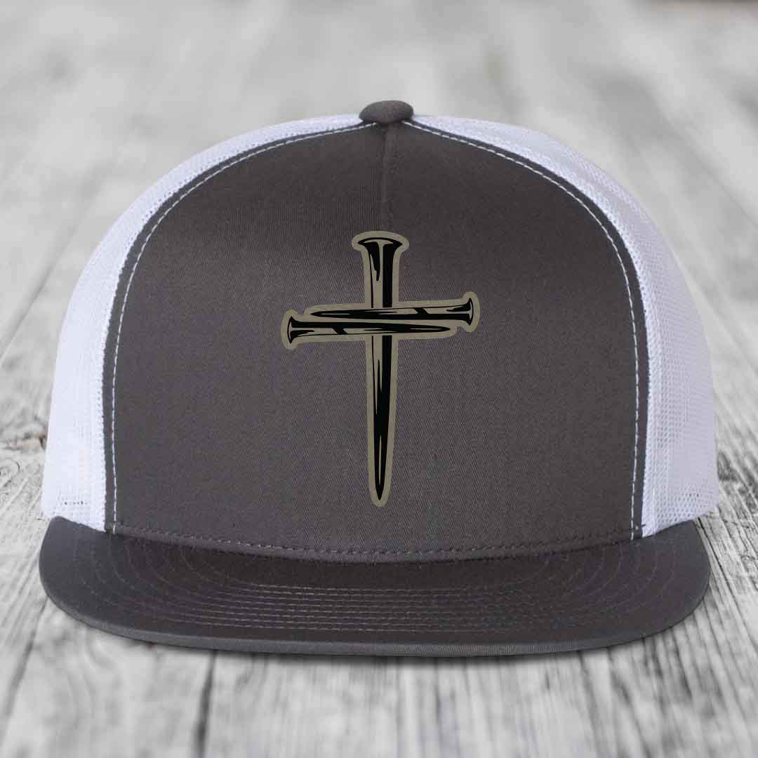 Black snapback hat with a cross made of nails patch on front.