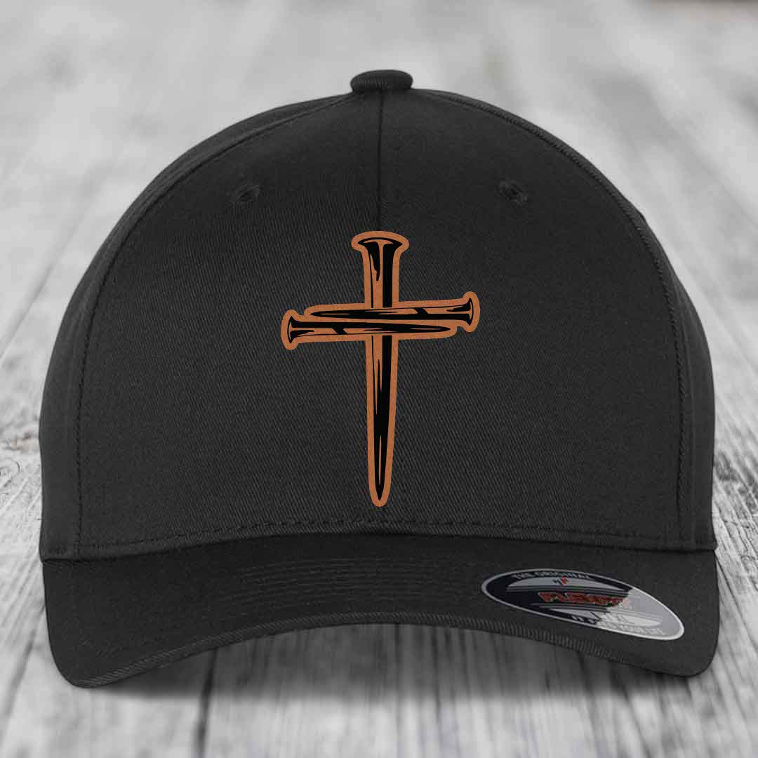 Black baseball cap with a brown and black cross of nails patch on front.