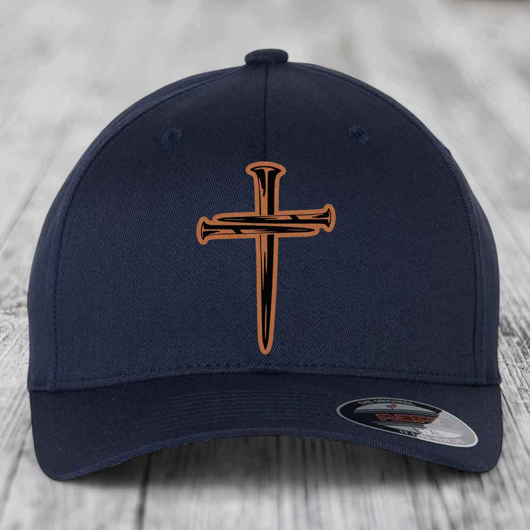 Red baseball cap with black and tan cross of nails patch on front.