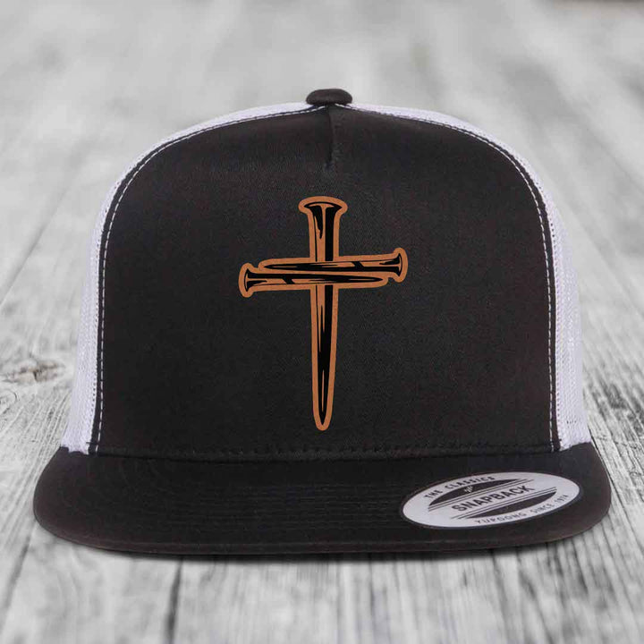 Grey trucker hat with a cross made of nails patch on front.