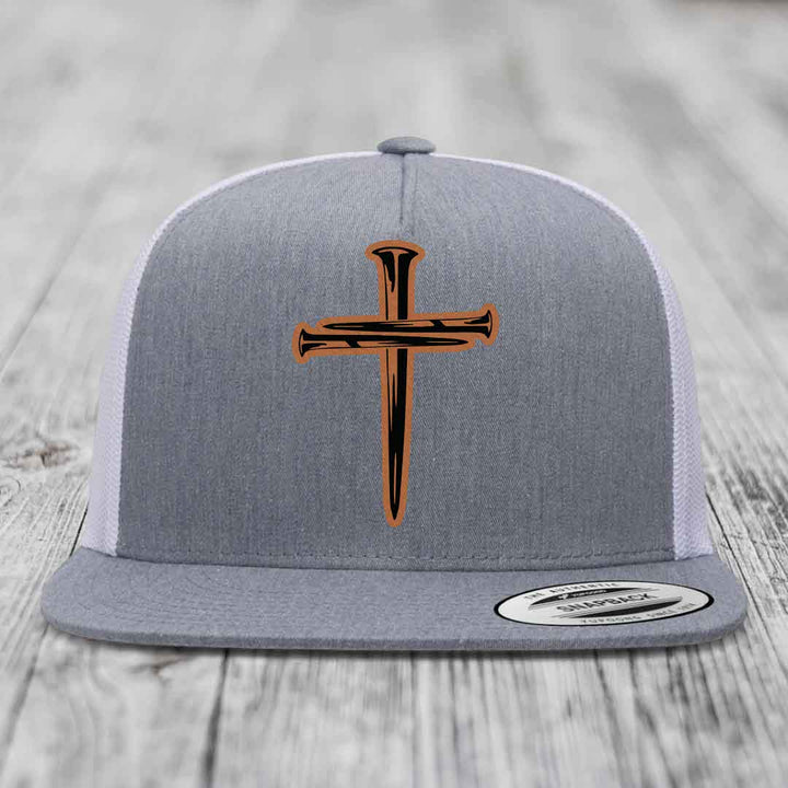 Grey front panel trucker hat with black and orange cross of nails patch.
