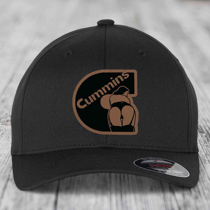 Tan baseball cap with black Cummins logo patch featuring a stylized figure.