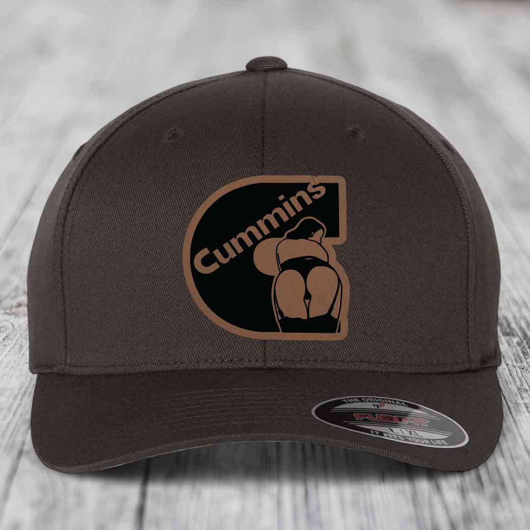 Dark brown Flexfit hat with Cummins logo patch featuring a stylized figure and text.