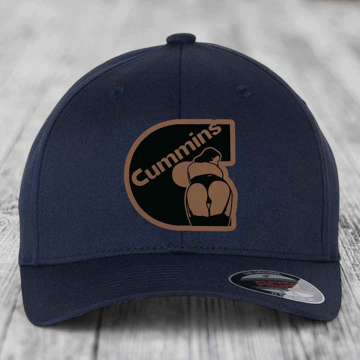 Dark blue baseball cap with a brown and black Cummins logo patch on the front.