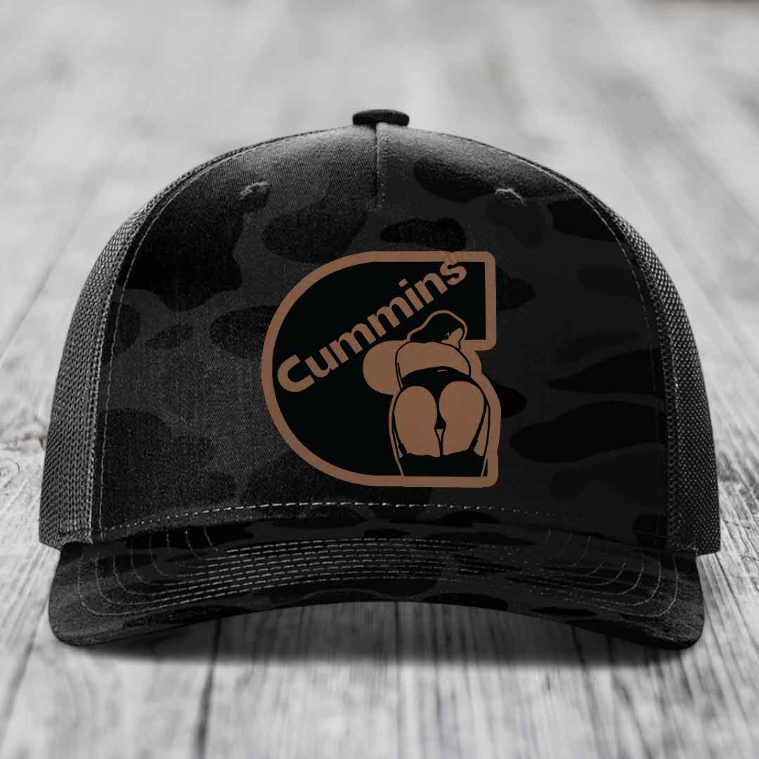 Camouflage trucker hat with Cummins logo patch featuring a stylized &