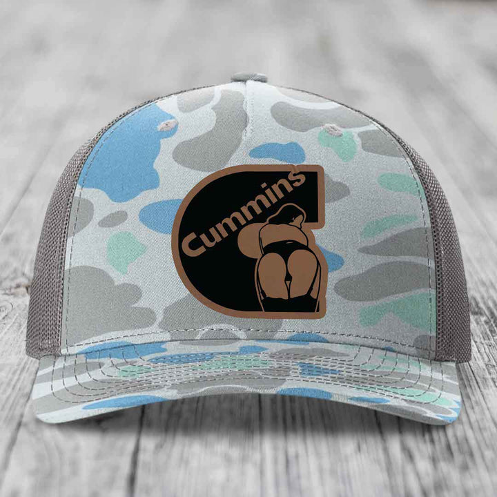 Black snapback trucker hat with brown leather patch featuring &