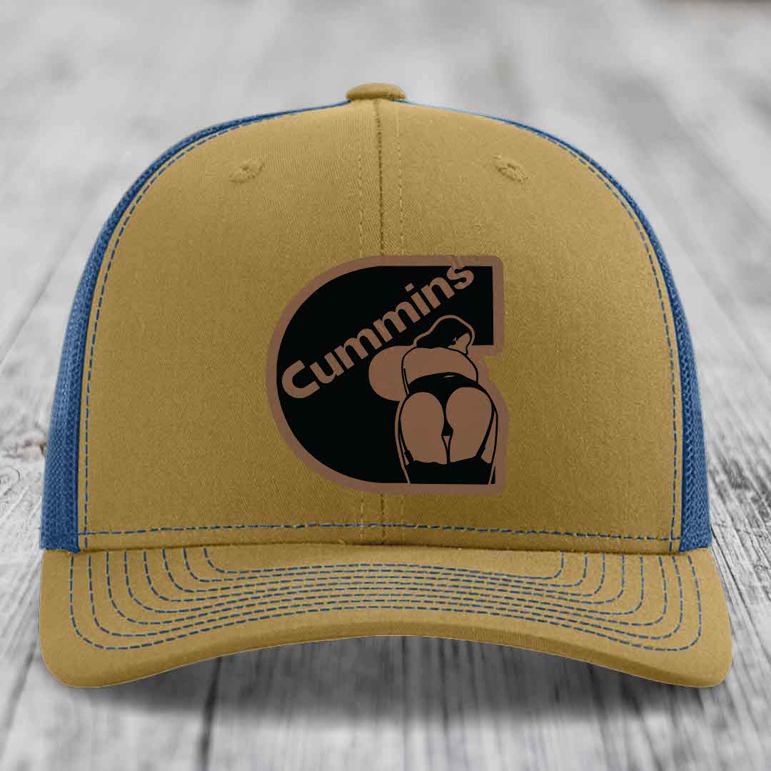 Black trucker hat with brown Cummins logo patch featuring a stylized engine graphic.