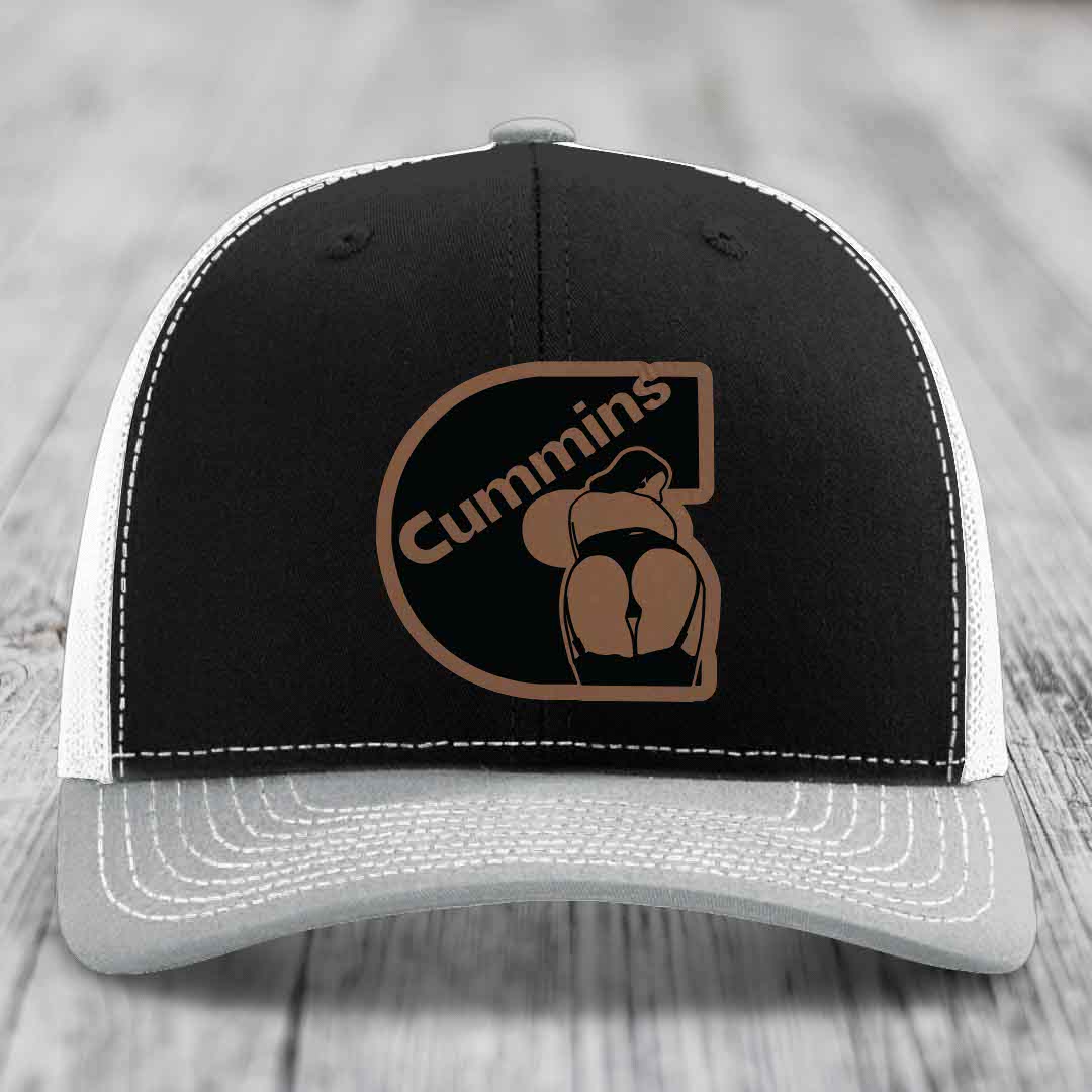 Brown trucker hat with white stitching and a black Cummins logo patch featuring a stylized engine.