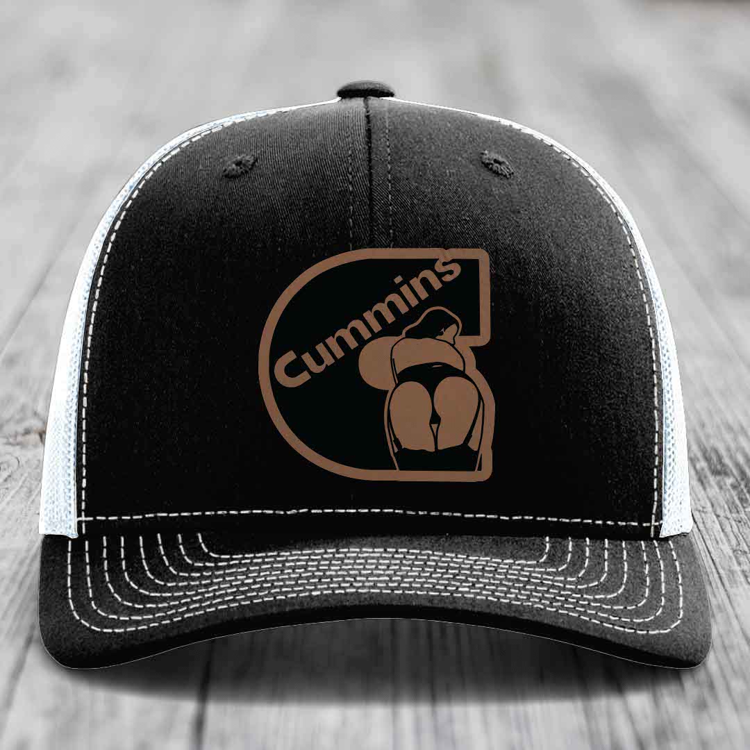 Black and white trucker hat with brown Cummins logo patch on front.