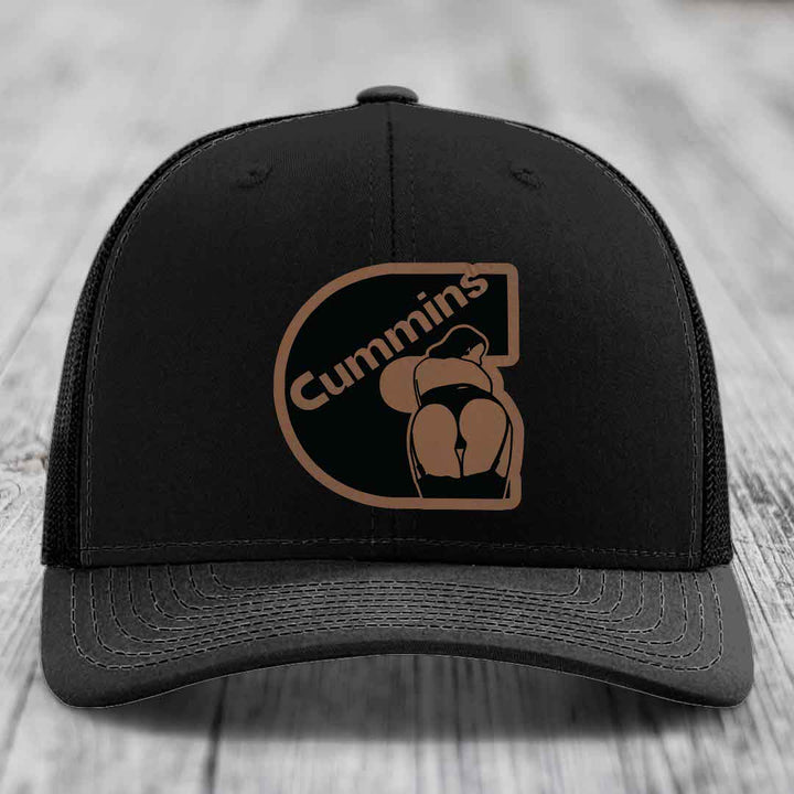 Tan and blue trucker hat with Cummins logo patch on front.