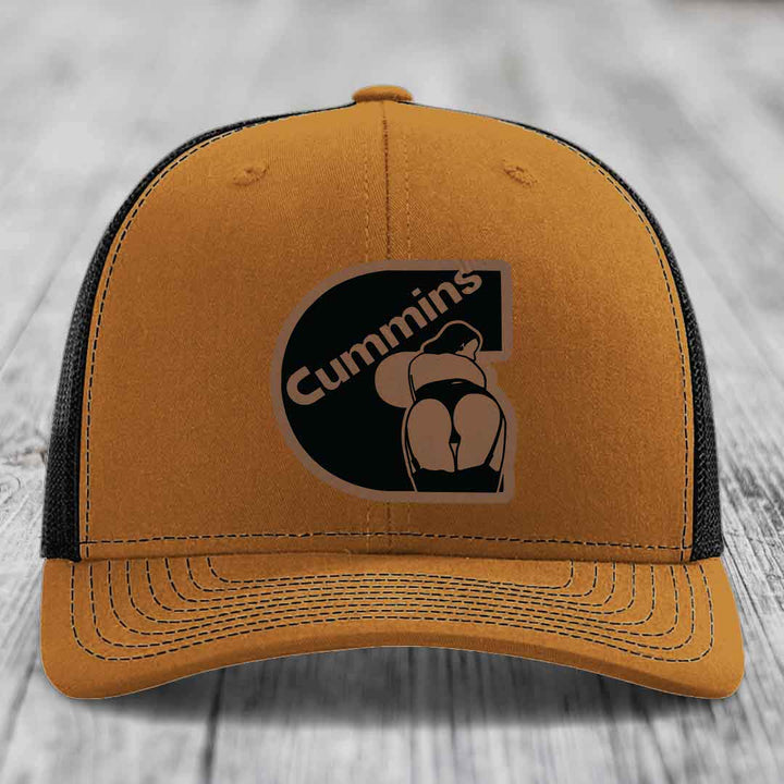 Grey trucker hat with black mesh back and brown leather patch featuring &