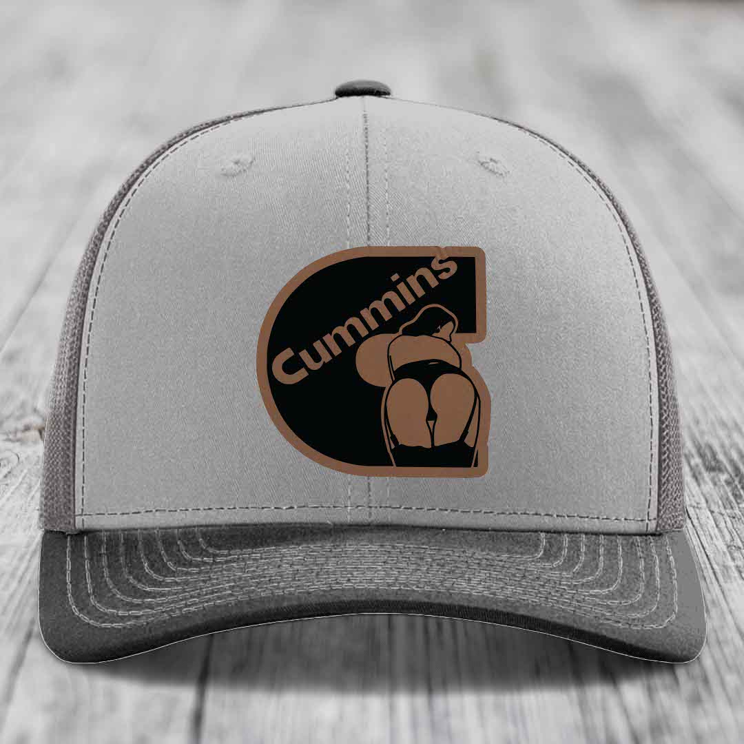 Grey and beige trucker hat with Cummins logo patch on front.