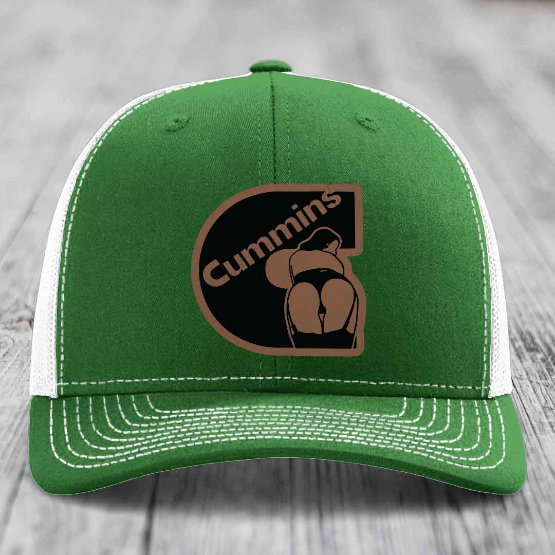 Beige trucker hat with black mesh back and brown leather patch featuring &