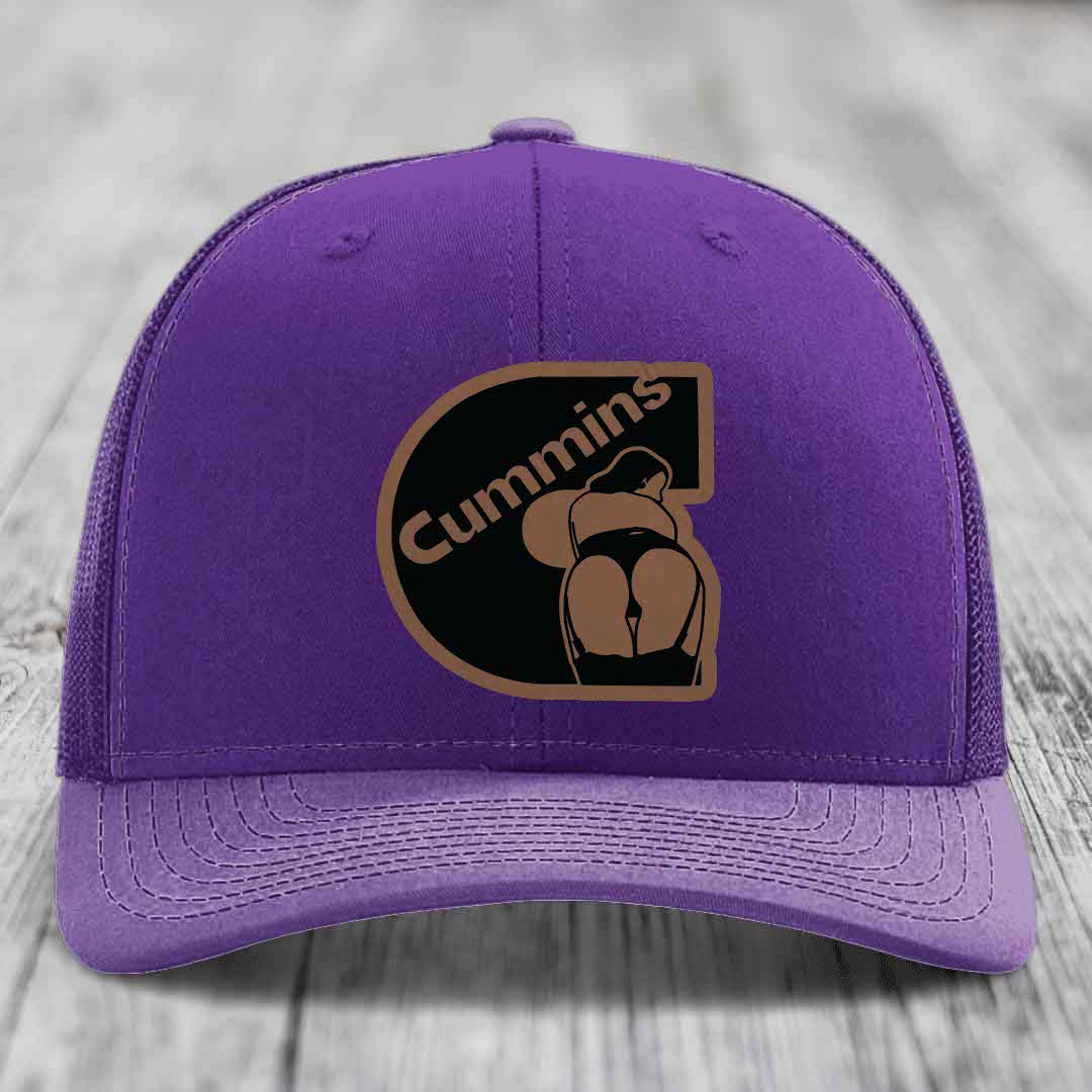Red trucker hat with black mesh back and Cummins logo patch on front.