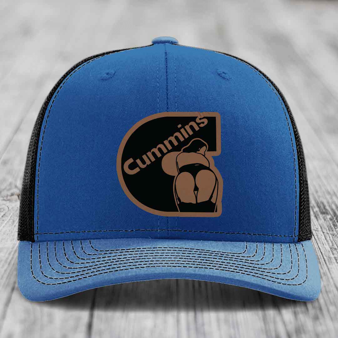 Blue and red trucker hat with Cummins logo patch on front, white mesh back, and white stitching.