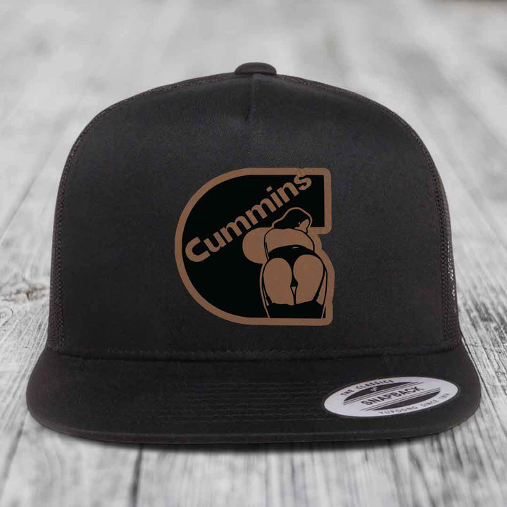 Black and white trucker hat with brown leather patch featuring &
