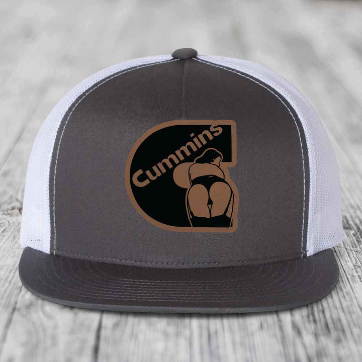 Red baseball cap with Cummins logo patch featuring a stylized &