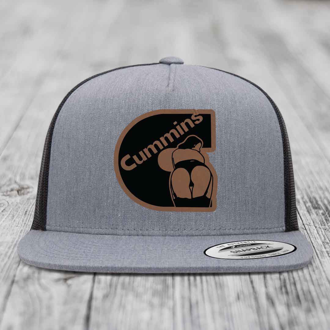 Grey trucker hat with brown and black Cummins logo patch featuring a stylized figure.