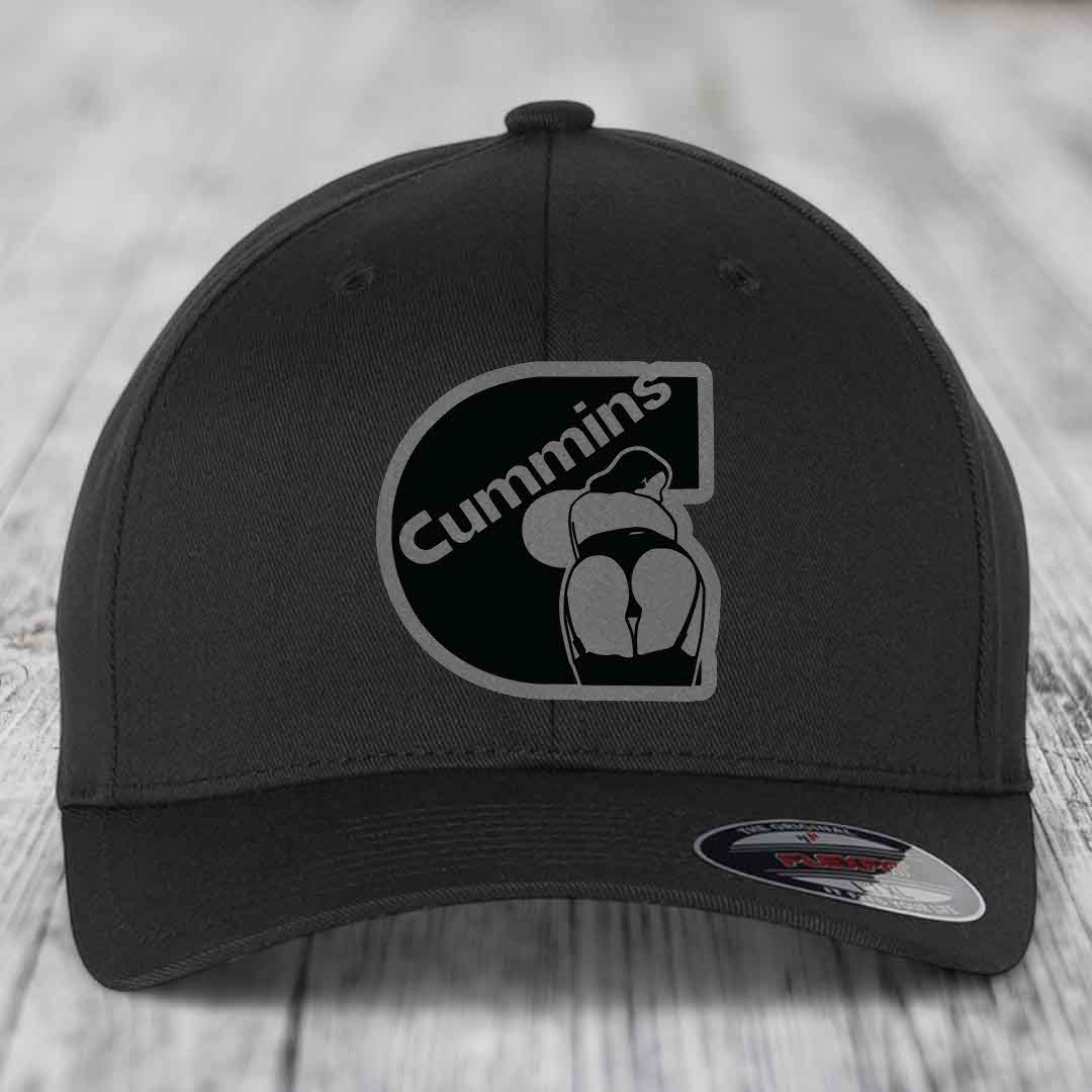 Tan baseball cap with black and grey Cummins logo patch on front, featuring a stylized &