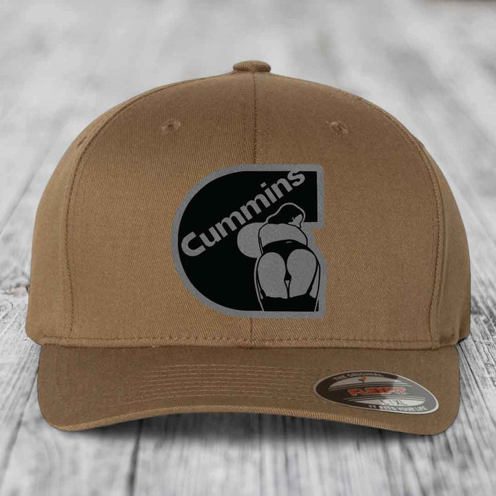 Brown Flexfit hat with Cummins logo patch featuring a stylized &