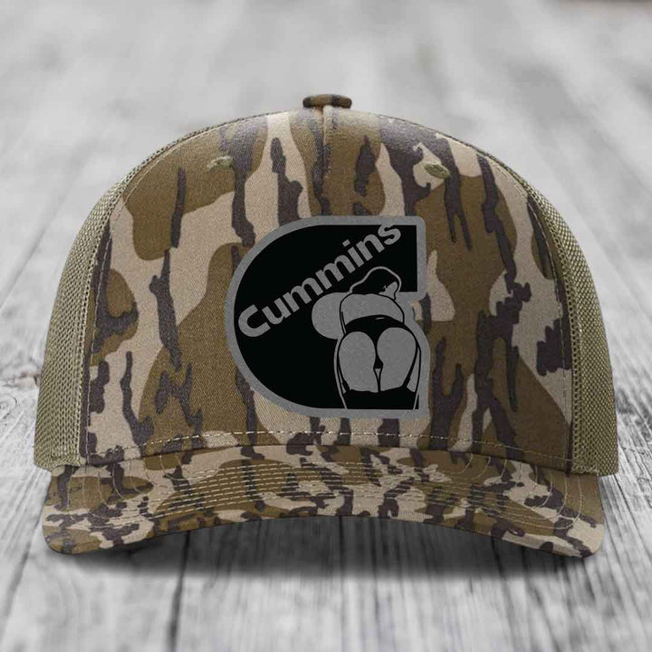 Blue and white trucker hat with a black Cummins logo patch on the front.