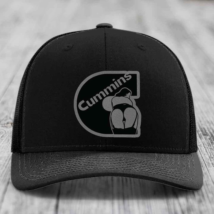 Tan and blue trucker hat with Cummins logo patch on front.
